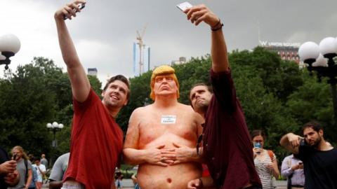 In pictures: Nude Donald Trump statues amuse crowds - BBC News