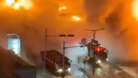 Reuters Fire engines at the scene of the fire