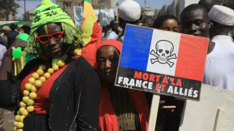 EPA Protesters, one holding a sign in French saying: "Death to France and its allies" in Bamako, Mali - Friday 14 January 2022
