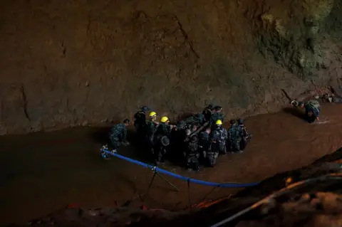 Reuters Soldiers and rescue workers work in Tham Luang cave complex