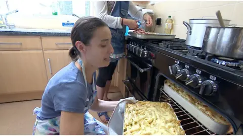 Volunteers cooking lunch at a charity