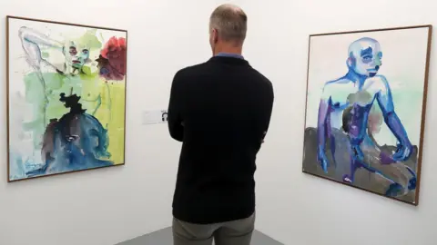 EPA A man looks at artworks by Banele Khoza from Swaziland on exhibit at the Zeitz Museum of Contemporary Art Africa (Zeitz MOCAA) at the V^A Waterfront in Cape Town, South Africa, 09 May 2018. This new exhibition in the Curatorial Lab of the Zeitz MOCAA in partnership with the Consulate General of the Netherlands investigates the lack of representation and current oppression of the LGBT community in Africa.