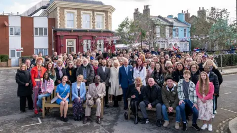 Reuters Prince Charles and Camilla, Duchess of Cornwall pose for a group photo with the cast and crew during a visit to the set of EastEnders at the BBC studios in Elstree,