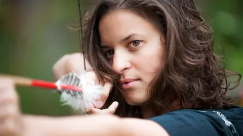 Getty Images Woman shooting an arrow