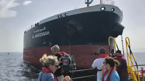 AFP Journalists view the damaged Saudi oil tanker Al-Marzoqah in the Gulf, 13 May