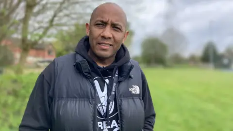 Delroy Ellis standing in a field