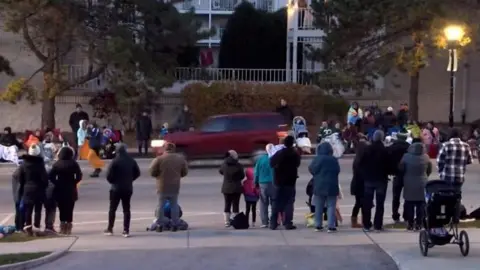 SUV speeds through parade