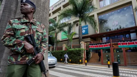 EPA Kenyan police officer stands guard at the entrance of the Westgate Mall in Nairobi, Kenya, 21 September 2023