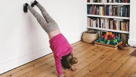 Instagram/@MightyMother_ Girl doing handstand