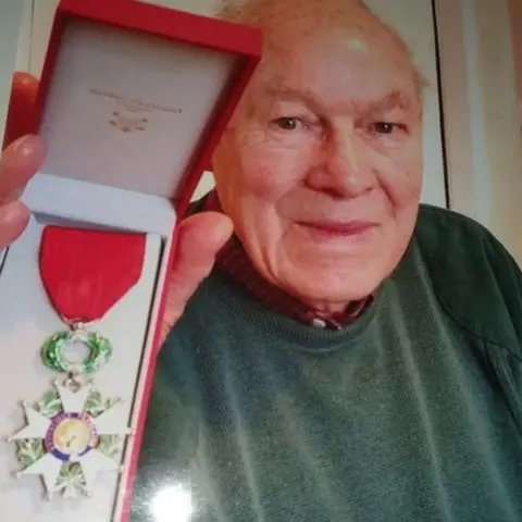 Family hand out Bert Vincent with medal