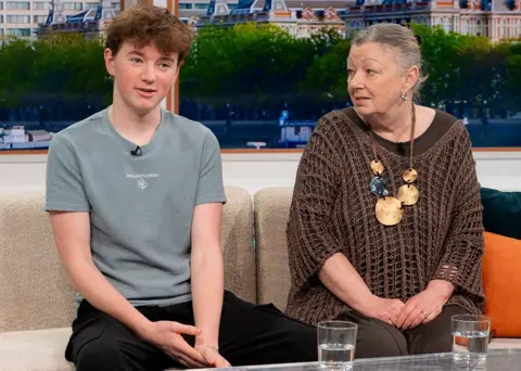 ITV / Shutterstock Alex Batty and his grandmother Susan Caruana sit on a sofa while talking during an interview for Good Morning Britain