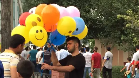 BBC A balloon seller in a Tashkent, Uzbekistan street