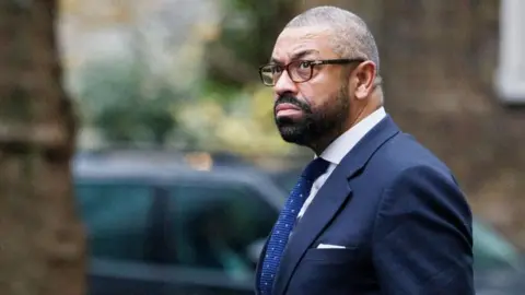 Home Secretary James Cleverly apologises for 'ironic joke' about spiking  wife's drink