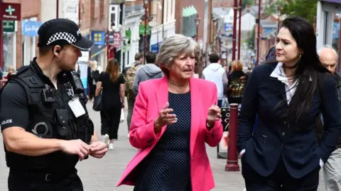 Derbyshire Police and Crime Commissioner Angelique Foster (centre) with a officer (left) and Councillor Carol Hart (right)