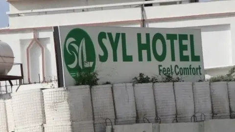 AFP via Getty Images Somali government soldiers seen at the entrance of the Syl hotel in Mogadishu in 2019