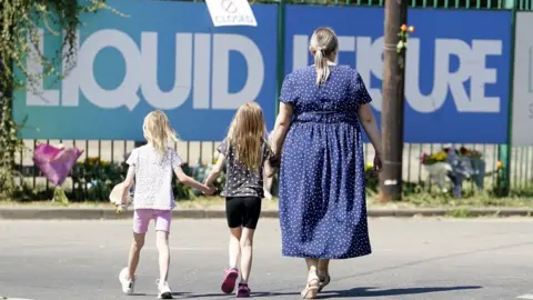 PA Media People leaving flowers outside Liquid Leisure on Sunday afternoon