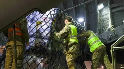 Ministry of Defence RAF Airbus A400M military transport plane being loaded with UK aid for the onward journey in support of the earthquake in Turkey and Syria, at Brize Norton base on 9 February 2023