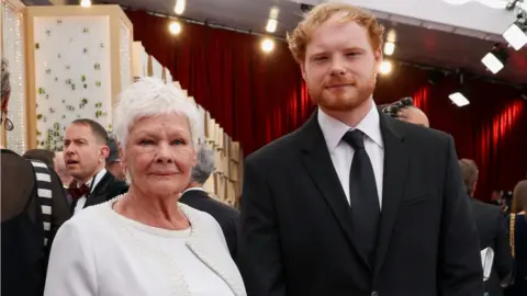 MIKE BLAKE/REUTERS Judi Dench and Sam Williams