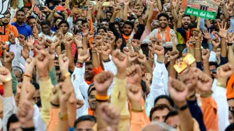 Getty Images Supporters of the Bharatiya Janata Party (BJP) celebrate the election results.