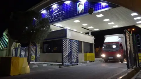 AFP A handout photo from the Atomic Energy Organisation of Iran showing a lorry carrying uranium hexafluoride leaving the Natanz facility in Iran (6 November 2019)