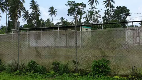 REFUGEE ACTION COALITION A barbed wire fence outside an asylum seeker compound on Manus Island