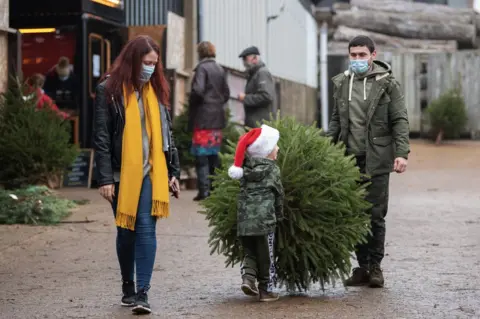 PA Media A family collecting a Christmas tree in Rutland