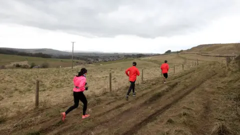 Reuters Joggers run in Buxton as the spread of the coronavirus disease (COVID-19) continues, Buxton, Britain