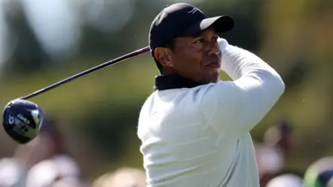Tiger Woods of the United States plays his shot from the 18th tee