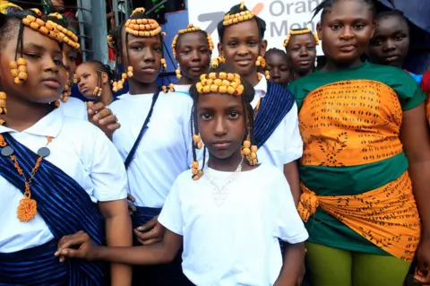EPA Girls with matching braids and clothes pose for the camera.