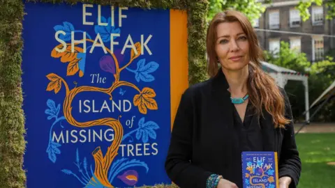 Getty Images Elif Shafak with her last book, The Island of Missing Trees