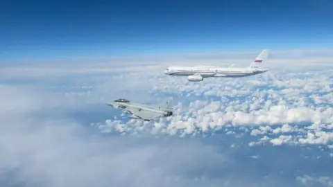 UK Crown Copyright RAF Typhoon, left, and Russian Tu-214