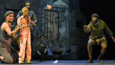 Fiona McPherson/Courtesy Baxter Theatre Scene from The Life and Times of Michael K with Craig Leo, Nolufefe Ntshuntshe, Carlo Daniels, Faniswa Yisa and Billy Langa