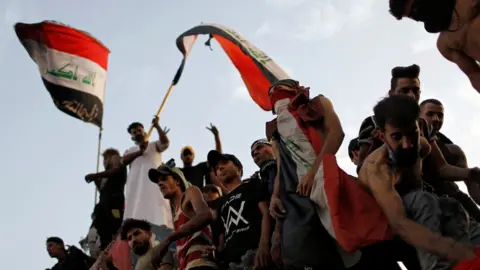 Reuters Iraqis gather to mark the first anniversary of the start of anti-government protests in Baghdad, Iraq (25 October 2020)