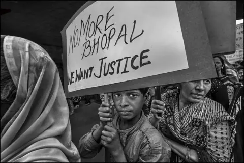 Judah Passow Demonstrators marching through the street of Bhopal to mark the 34th anniversary of the Union Carbide chemical plant disaster