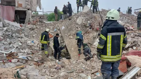 Ukraine's DSNS emergency service Rescuers seek for survivors under the rubble of a destroyed five-storey house in Chasiv Yar, eastern Ukraine. Photo: 11 July 2022