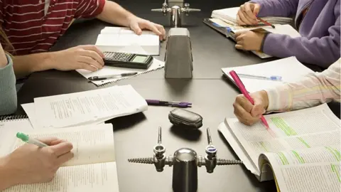 Getty Images Students studying at college