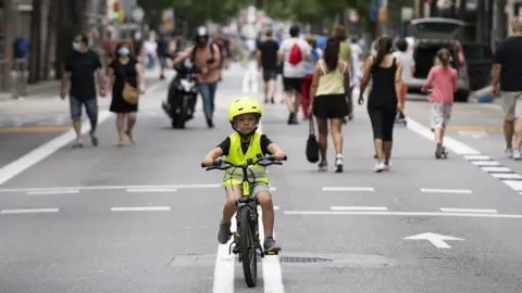 Getty Images A boy rides a bicycle on a road turned into a pedestrian street on weekends in Barcelona