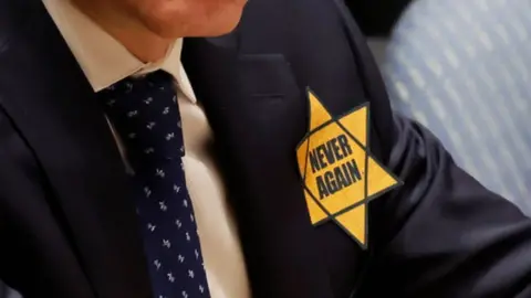 Israeli ambassador with yellow star on suit