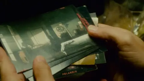 Ladd Company/Ridley Scott/Warner Bros Deckard flicks through a set of Polaroid photographs