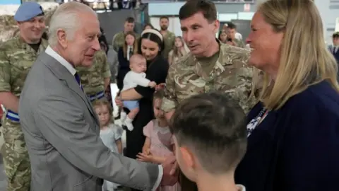 PA Media King Charles meeting staff member and their families at the Army Aviation Centre in Hampshire