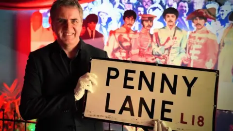 PA Media Steve Rotheram and sign