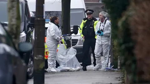 Getty Images Police and forensic officers at Matlock Road