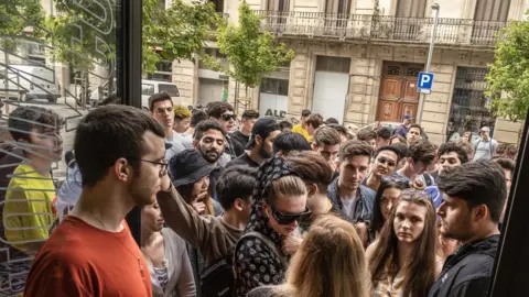 Getty Images People queuing for a Adidas Yeezy trainer drop