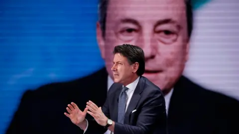 Italian president of the 5 Star Movement Giuseppe Conte guest at the television program Porta a Porta. In the background Mario Draghi. Rome (Italy), May 11th, 2022