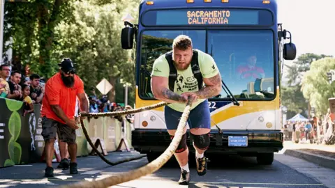Joe Martinez/World's Strongest Man Tom Stoltman bus pull