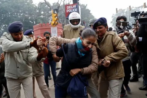 Reuters A demonstrator is detained during a protest against a new citizenship law, in Delhi, India, December 19, 2019.