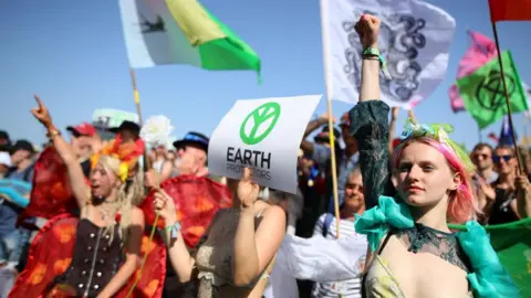 PA Media Extinction Rebellion march at Glastonbury Festival