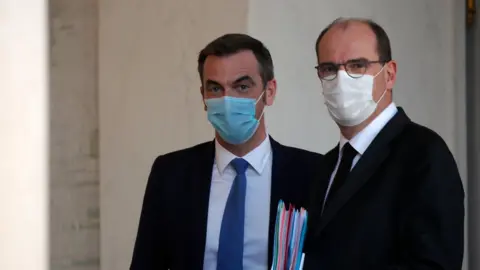 Reuters French Prime Minister Jean Castex and Health Minister Olivier Veran, wearing protective face masks, leave following the weekly cabinet meeting