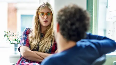 Getty Images Man and a woman working in an office together