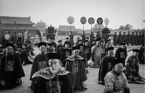 ADRIAN BRADSHAW People prepare for a film scene